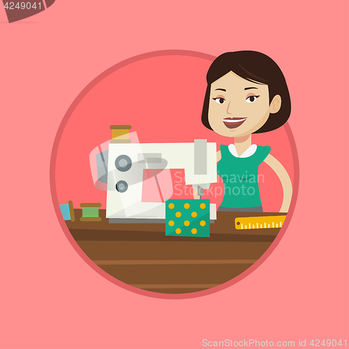 Image of Seamstress using sewing machine at workshop.