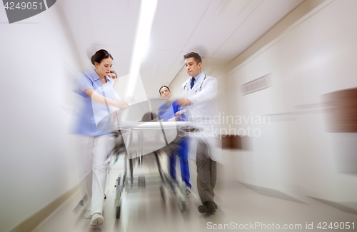 Image of medics and patient on hospital gurney at emergency