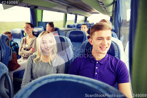 Image of happy couple or passengers in travel bus