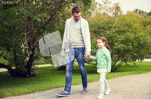 Image of happy family walking in summer park