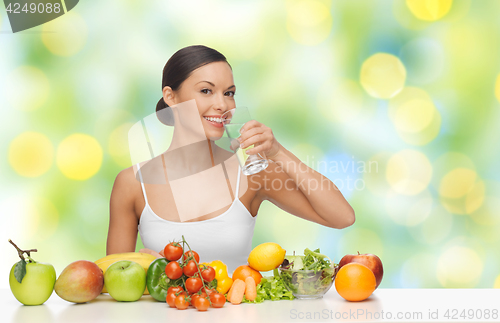 Image of happy woman with glass of water and healthy food