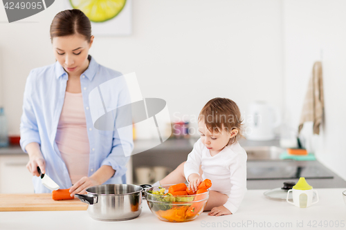 Image of happy mother and baby cooking food at home kitchen