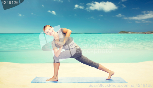 Image of woman making yoga low angle lunge pose on mat