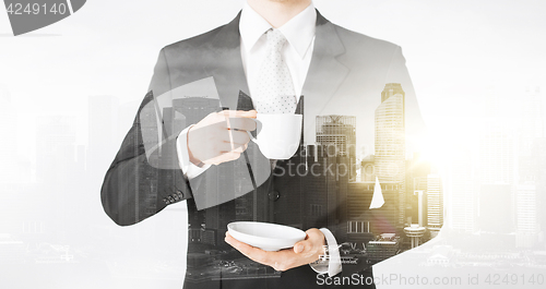 Image of close up of businessman drinking coffee from cup