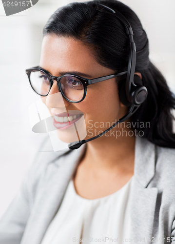 Image of businesswoman with headset talking at office