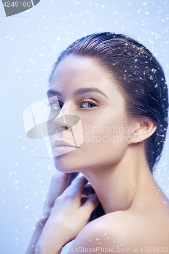 Image of Beautiful woman face portrait close up on blue