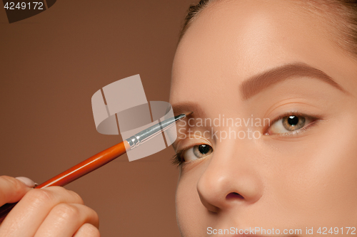 Image of Beautiful female eyes with make-up and brush