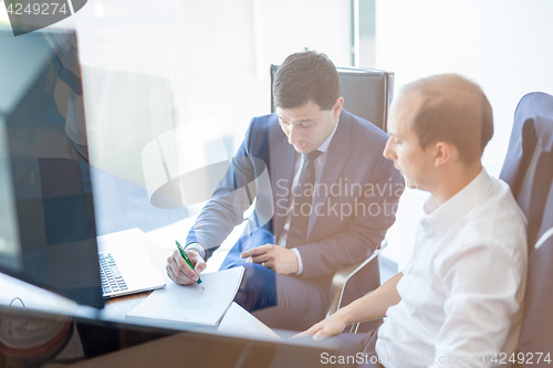 Image of Two businessmen discussing a bisiness problem at meeting in trading office.