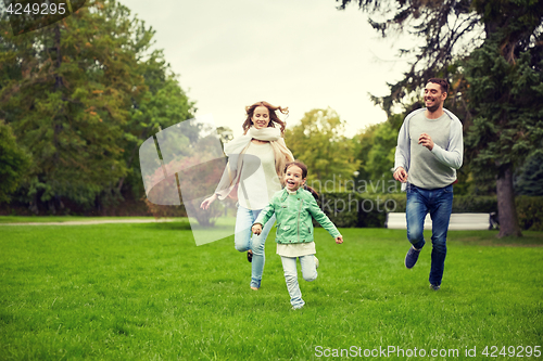 Image of happy family walking in summer park