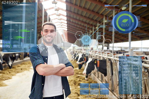 Image of man or farmer with cows in cowshed on dairy farm