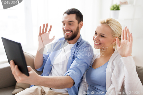 Image of couple with tablet pc having video chat at home
