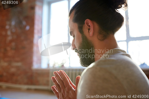 Image of close up of man meditating at yoga studio