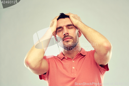 Image of unhappy man suffering from head ache