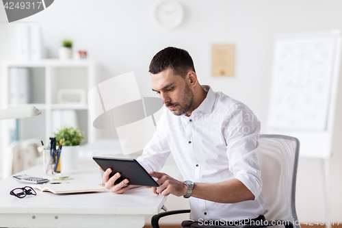 Image of businessman with tablet pc at office