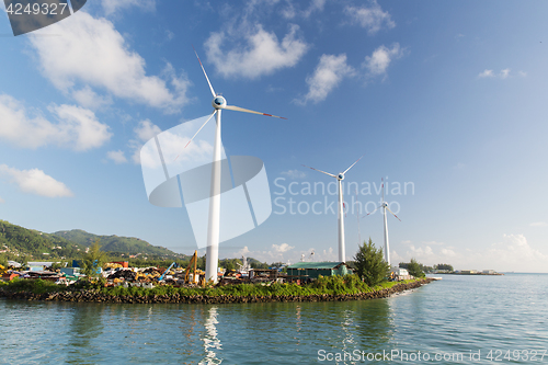 Image of turbines at wind farm on sea shore