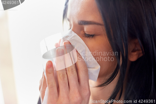 Image of close up of woman with wipe blowing nose or crying