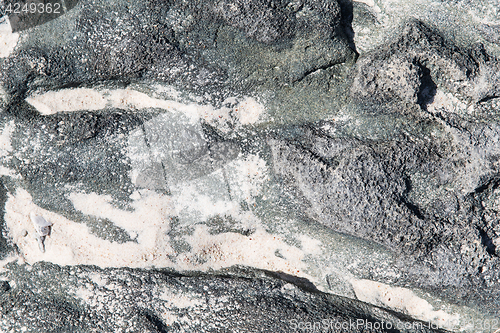 Image of close up of stone or volcanic rock with sand