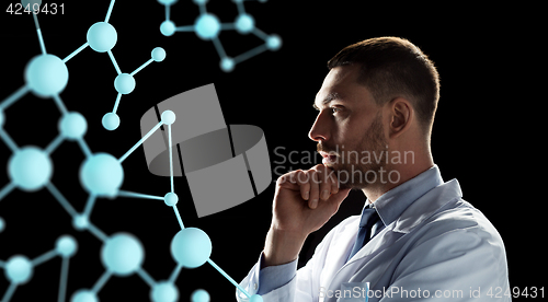 Image of scientist looking at molecule projection