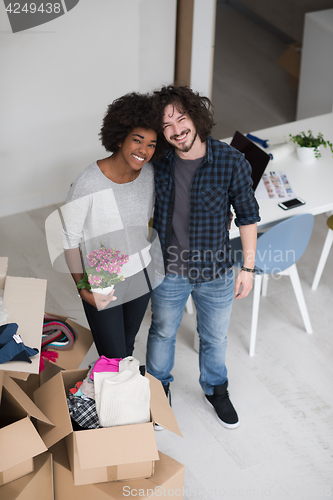 Image of multiethnic couple moving into a new home