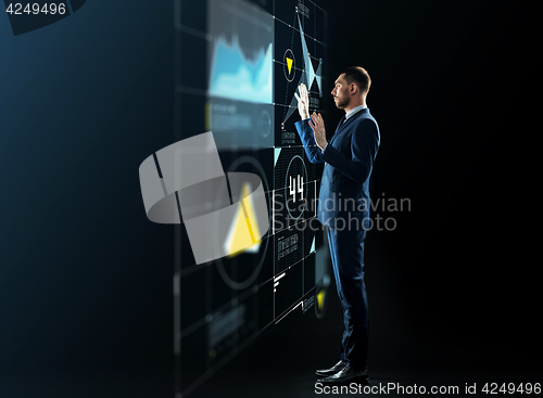 Image of businessman working with virtual projection