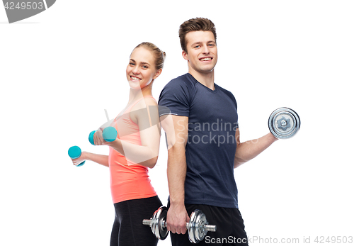 Image of sportive man and woman with dumbbells