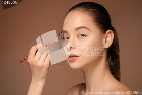 Image of Beautiful female eyes with make-up and brush