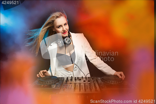 Image of Beautiful blonde DJ girl on decks - the party,