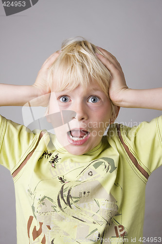 Image of Portrait of a young boy shouting