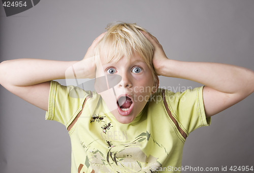 Image of Portrait of a young boy shouting