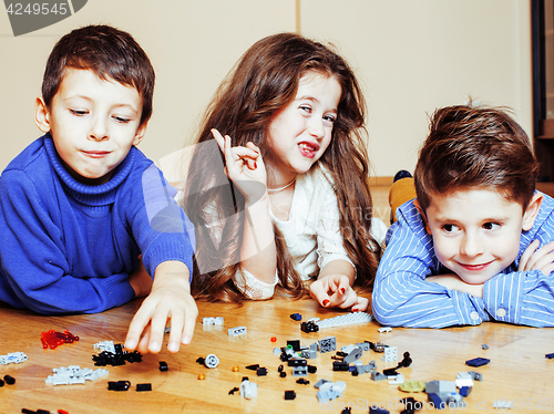 Image of funny cute children playing toys at home, boys and girl smiling,