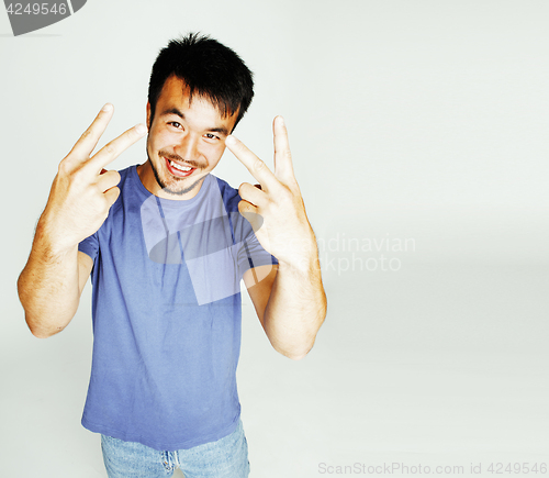 Image of young cute asian man on white background gesturing emotional, po