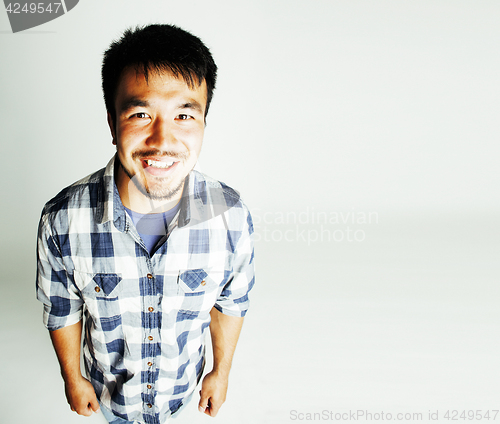 Image of young cute asian man on white background gesturing emotional, po