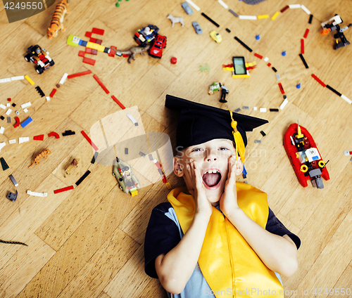 Image of little cute preschooler boy among toys lego at home in graduate 