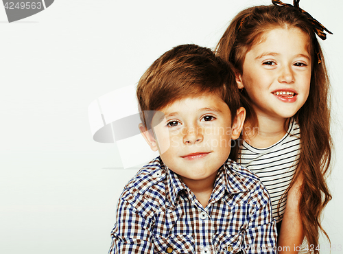 Image of little cute boy and girl hugging playing on white background, ha