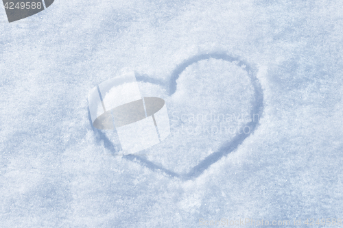 Image of The shape of heart painted on the snow 