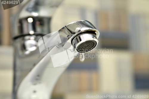 Image of Bathroom tap leaking water drops