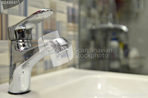 Image of Bathroom tap leaking water drops