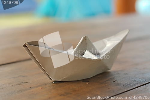 Image of Paper boat on a table
