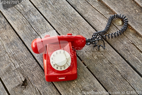 Image of Old telephone on wooden boards