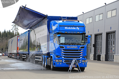 Image of Scania Woodchip Truck Dumps Water