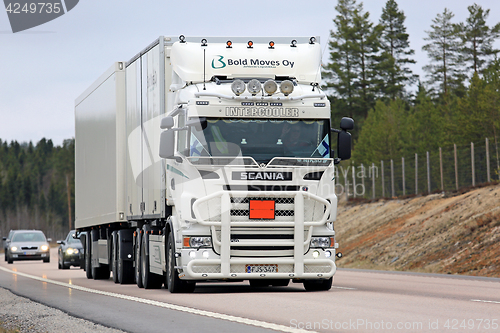 Image of White Customized Scania Cargo Truck on the Road
