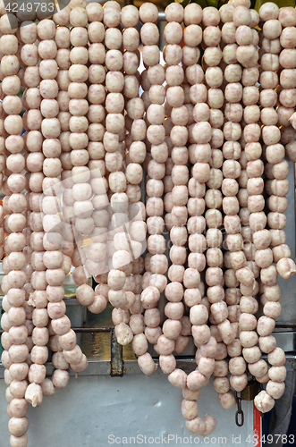 Image of Raw Isaan sausage on market