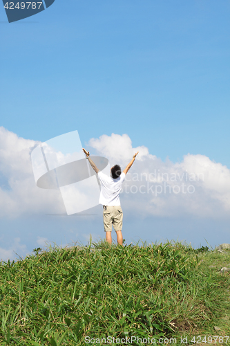 Image of Meeting of the sky. The man on high mountain with the hands lift