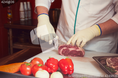 Image of Chef cutting meat