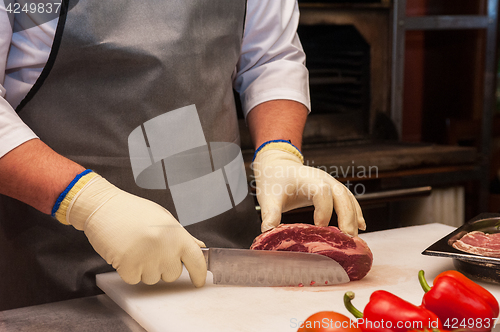 Image of Chef cutting meat