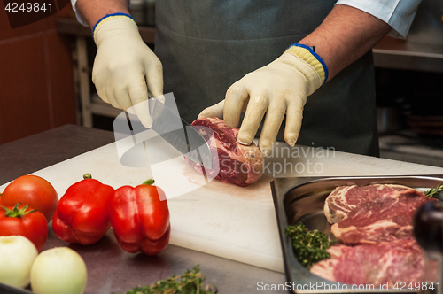 Image of Chef cutting meat
