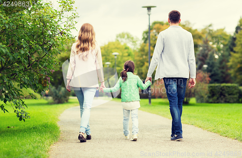 Image of happy family walking in summer park