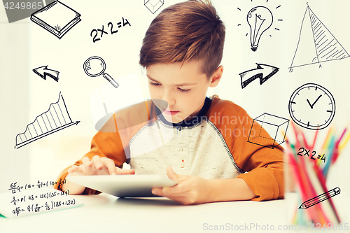 Image of close up of boy with tablet pc computer at home