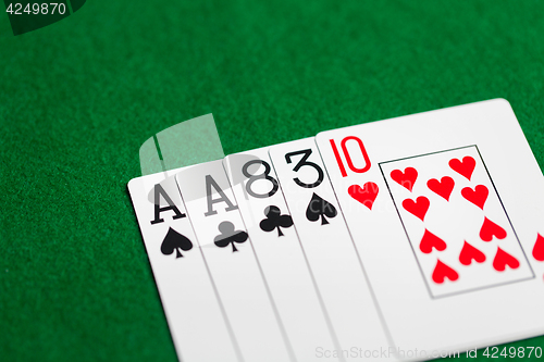 Image of poker hand of playing cards on green casino cloth