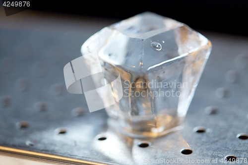 Image of hand-cut ice cube at bar